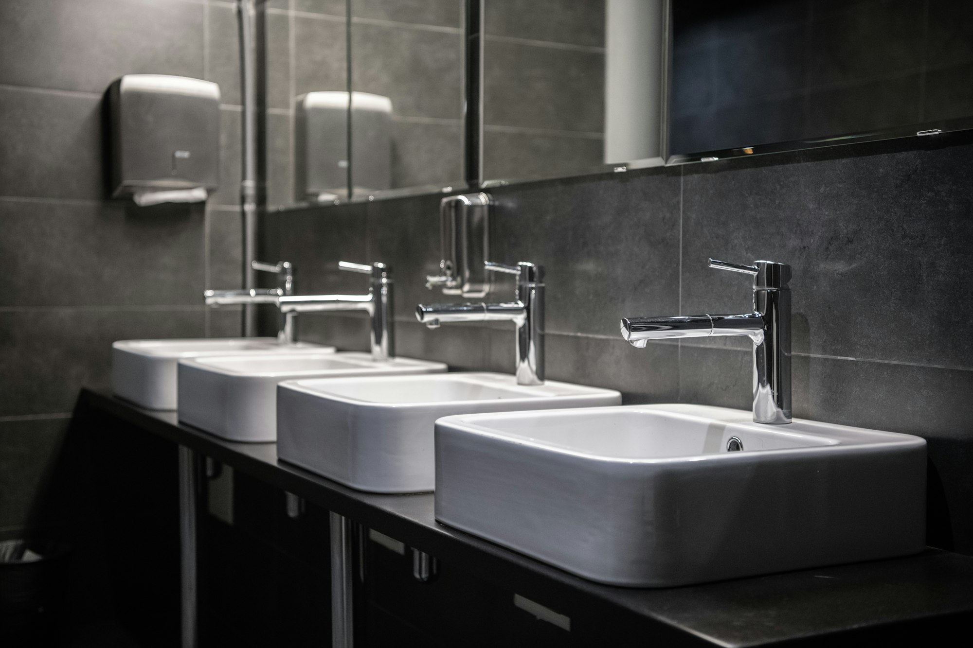 Interior of a modern public bathroom toilet in grey colors