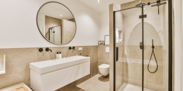 a bathroom with a shower sink and a mirror